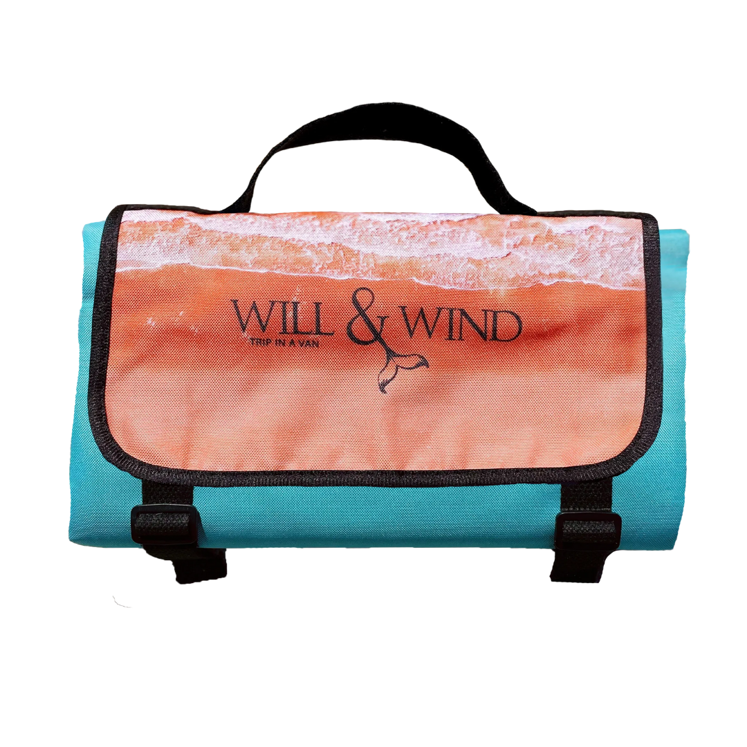 Kimberley Beach MatExclusive design by Trip In A VanThe Kimberley; Inspired by the turquoise blues and red pindan sands of Roebuck Bay, Broome WA FINALLY a mat you can throw down anywhere, anytime! The top side of our beach mats are made from an exceptionally durable, hard-wearing, yet soft feeling Oxford fabric. The rugged versatility of this material is perfect for outdoor conditions due to its water and mildew resistant qualities. Watch the spilt drinks bead off, and wipe clean for an instant dry feeling