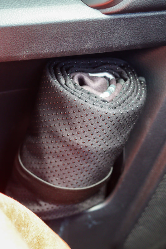 Will and Wind car seat towel rolled up and in the car door pocket alternate view