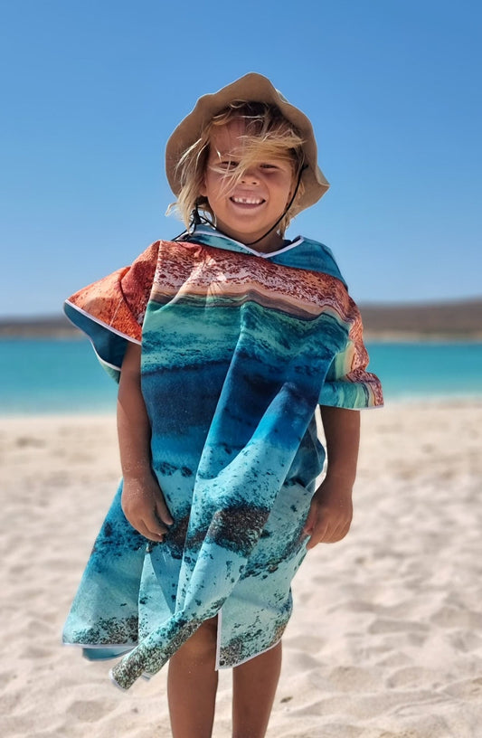 Mini Ningaloo HoodedQuick Dry Kids Hooded TowelFor the beach, travelling, camping, swimming lessons and more!Sustainably made using post-consumer plastic bottles in the form of recycled Polyester (rPET) Exclusive design by Violeta Brosig of Blue Media ExmouthInspired by the rugged red ranges meeting the pristine waters of the Ningaloo Coasts fringing reef, just meters from the shore.$57.99Will and Wind